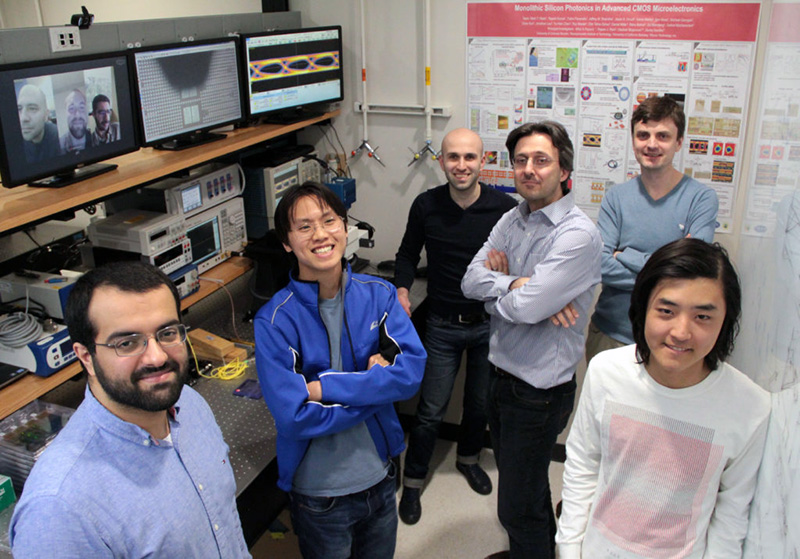 Boston University microchip team in their laboratory joined by co-lead authors, Amir Atabaki, Fabio Pavanello and Sajjad Moazeni