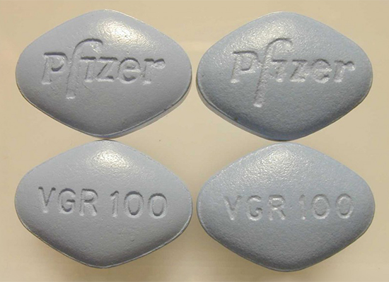 Real and counterfeit Viagra pills side by side. Real Viagra is on the right.