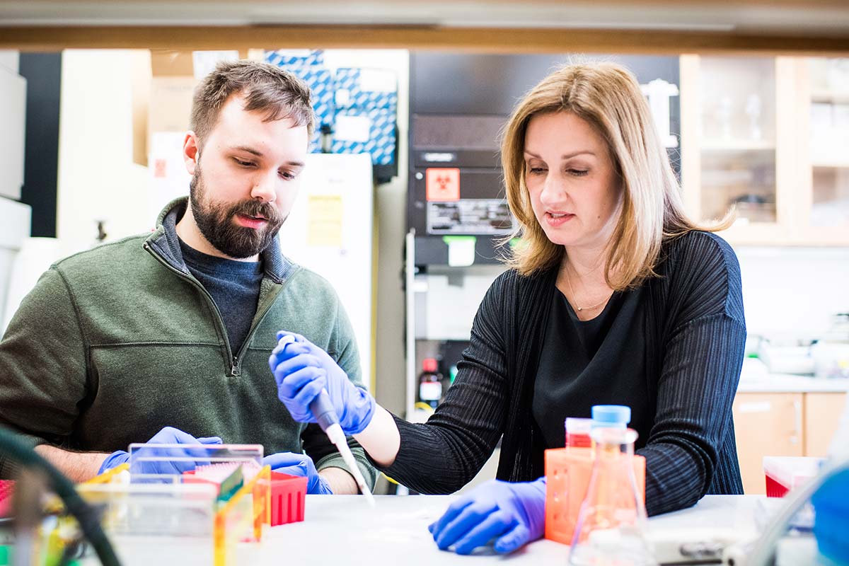 Catherine Klapperich, director of the Center for Future Technologies in Cancer Care (CFTCC) and professor of engineering at Boston University, working with a PhD candidate in her lab where they are developing point-of-care testing for malaria, chlamydia, gonorrhea, HPV, and more