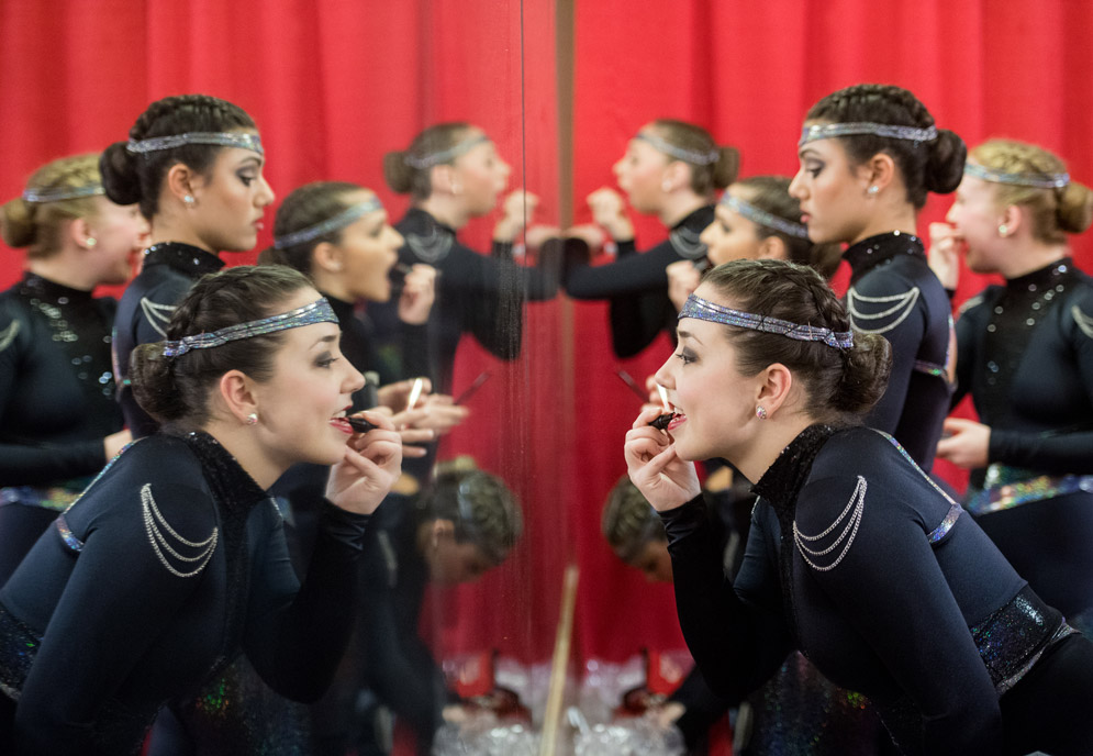 The dance team applies makeup for the showcase