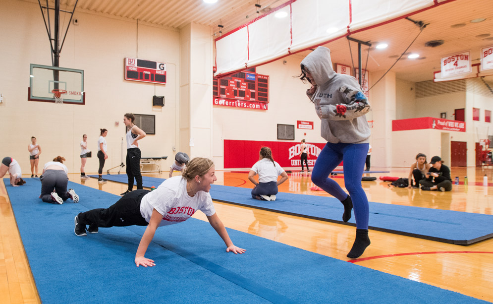 BU dance team practices on matts