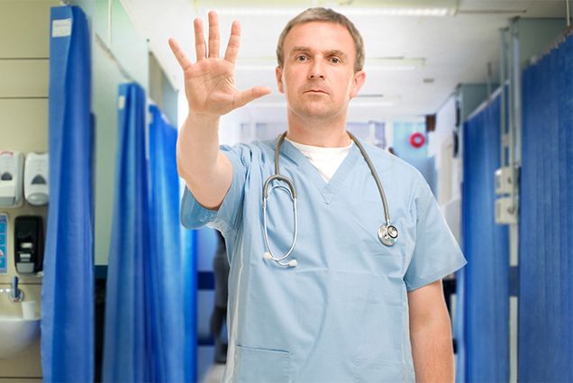 A doctor tries to de-escalate a dangerous situation halting and angry patient. Photo by sturti/iStock