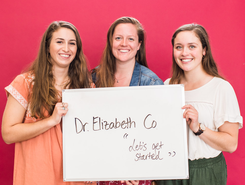 Students from Boston University's Class of 2018 hold a sign saying they'll miss their favorite professor