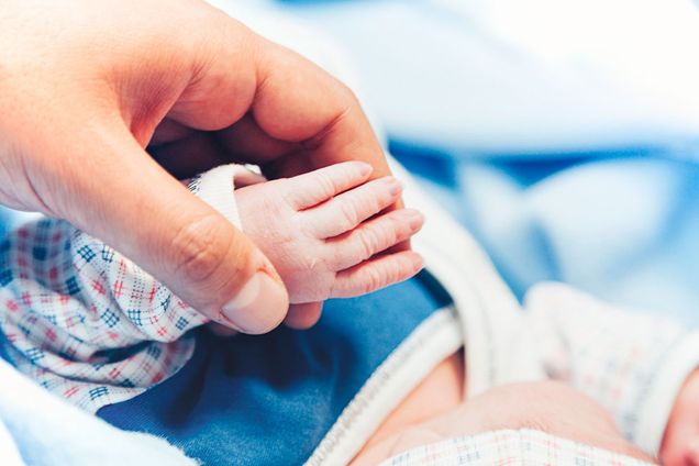 newborn baby hold mother finger on your hand
