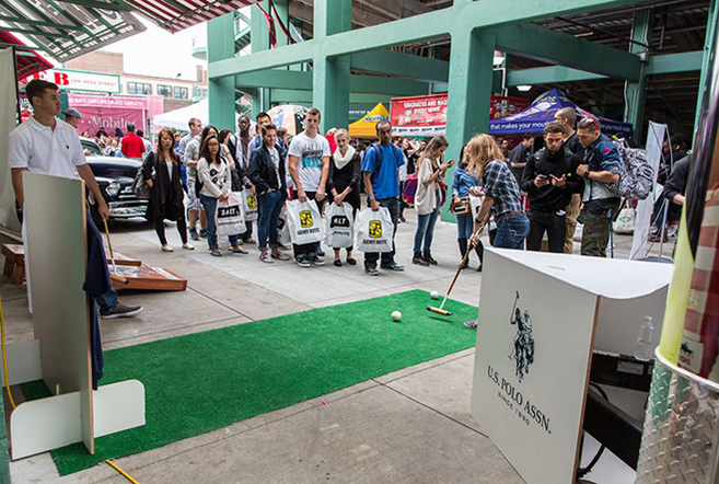 Students play putt-putt at CollegeFest at Fenway Park.