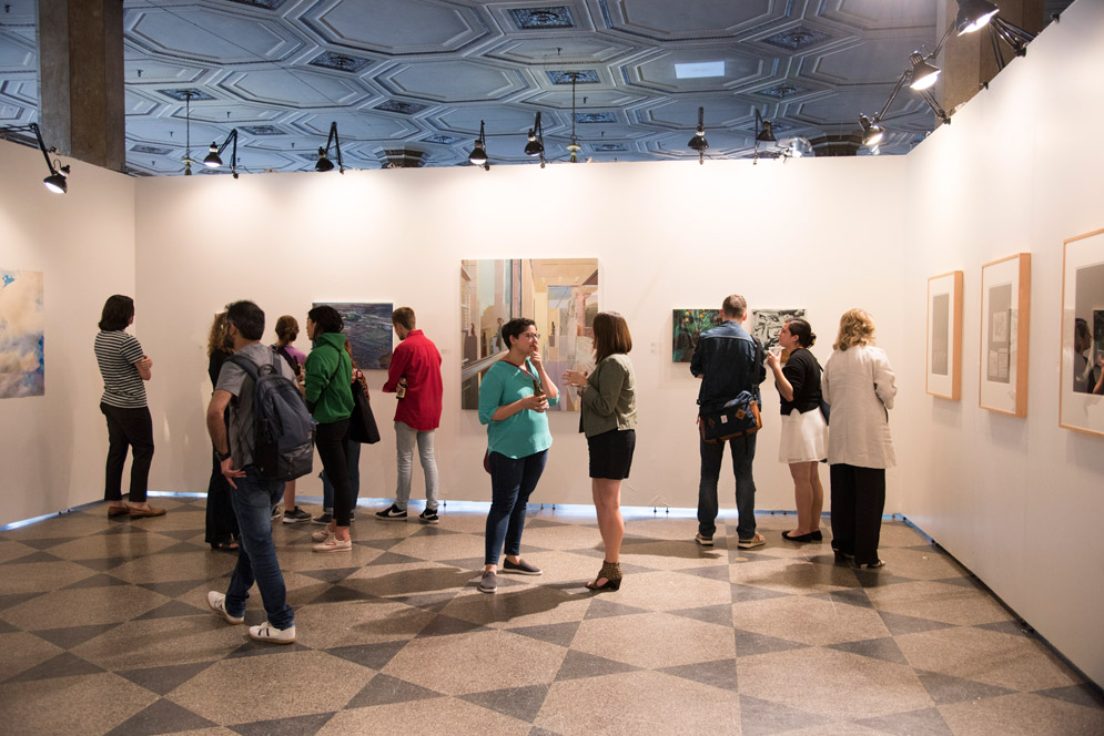 People mingle in "A Few Conversations Between Women" exhibit