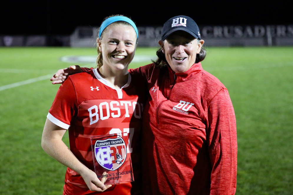 coach Nancy Feldman stands with Turnpike Trophy MVP Anna Heilferty after the soccer team's 300th win