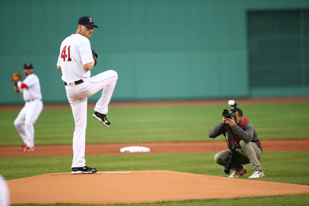 Weiss crouches down behind the pitchers mound to get a shot. 