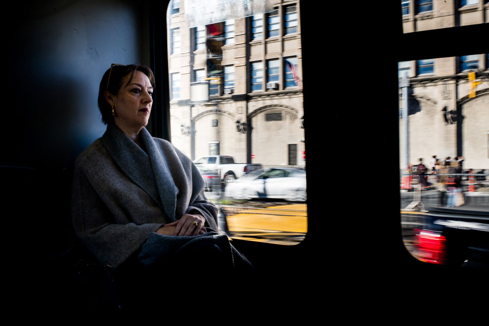 Photo of a woman riding the bus down commonwealth avenue.