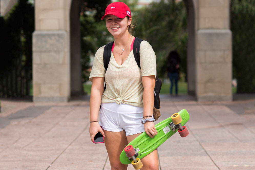 Erin Guevara (CAS'22) with her skateboard