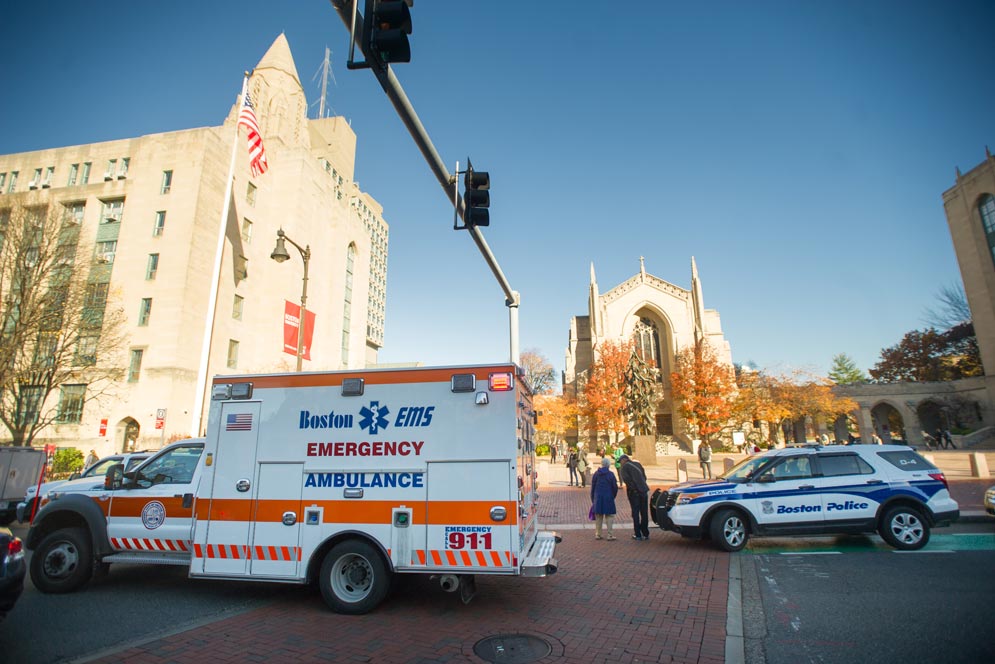 A BU police vehicle is parked in front of Marsh Chapel on a beautiful fall day.