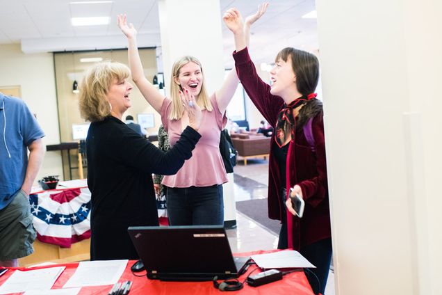 a student celebrates after successfully registering to vote