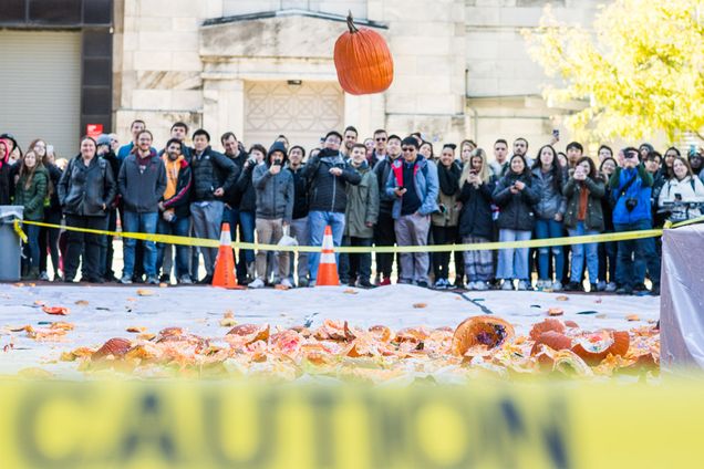 A pumpkin falls from the roof of the Metcalf Science Center during The 14th Annual Pumpkin Drop