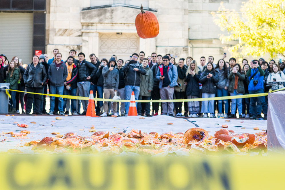 A pumpkin falls from the roof of the Metcalf Science Center during The 14th Annual Pumpkin Drop