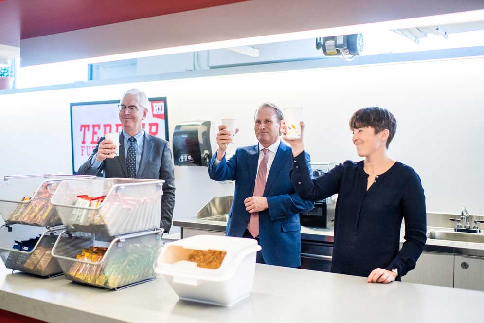 Those responsible for the new fuel station raise a toast.