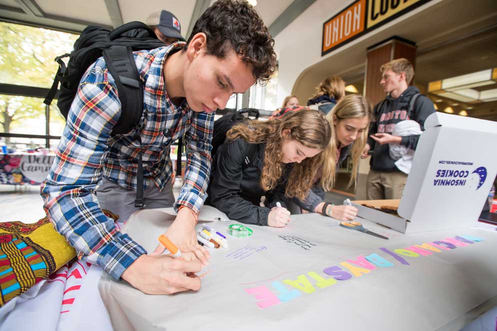 Students sign a Thank You banner for the dining hall staff