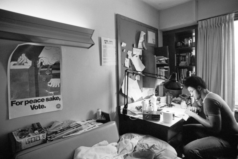 A poster hangs in a students room reading, "For peace sake, Vote"