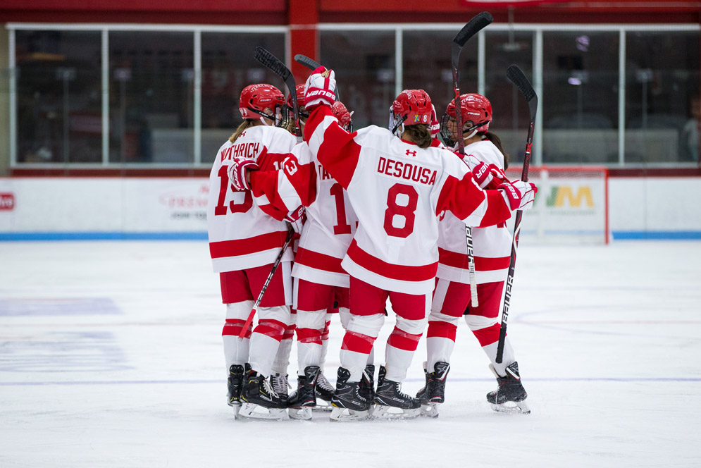 BU women’s hockey team huddles on the ice