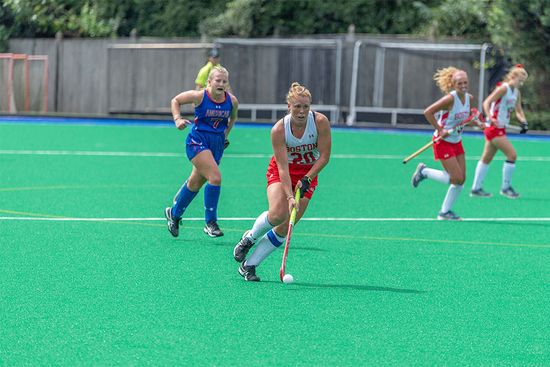 Boston University All-American field hockey back takes the ball down the field during a game.