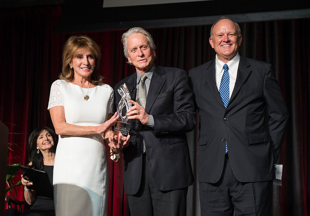 Actor Michael Douglas poses holding the Bette Davis Lifetime Achievement Award with Bette Davis Foundation founders Kathryn Sermak and Michael Merrill.