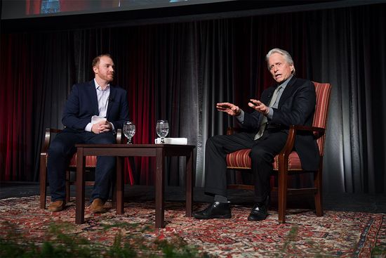 NPR host Jeremy Hobson leads a discussion with actor Michael Douglas on stage at the Boston University George Sherman Union.