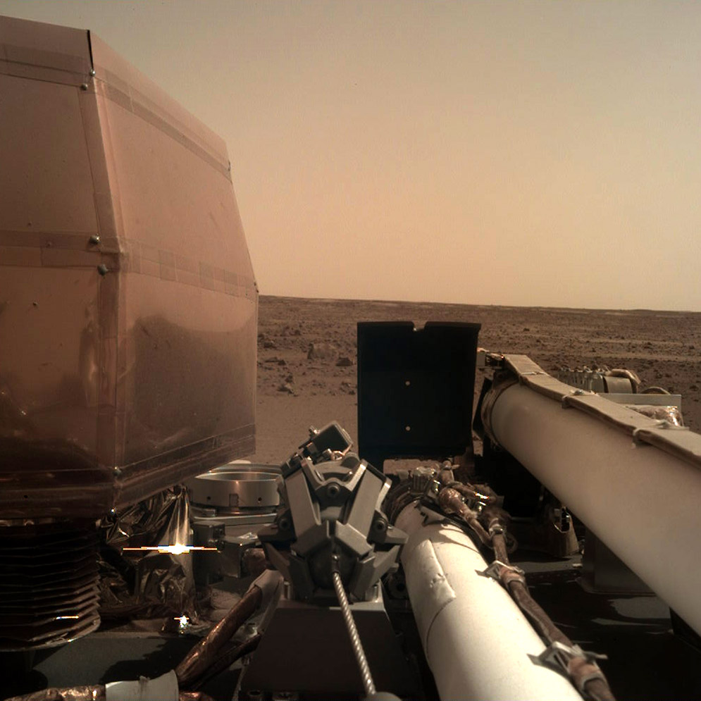 Photo of the surface of the planet Mars taken by a mounted camera on the NASA InSight Lander vehicle.