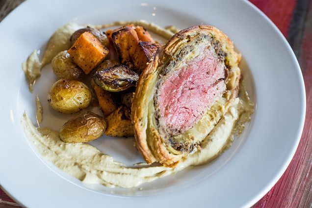 Beef Wellington plated with roasted potatoes, brussel sprouts, butternut squash, as prepared by the Flying Rhino Cafe and Watering Hole in Worcester, Massachusetts