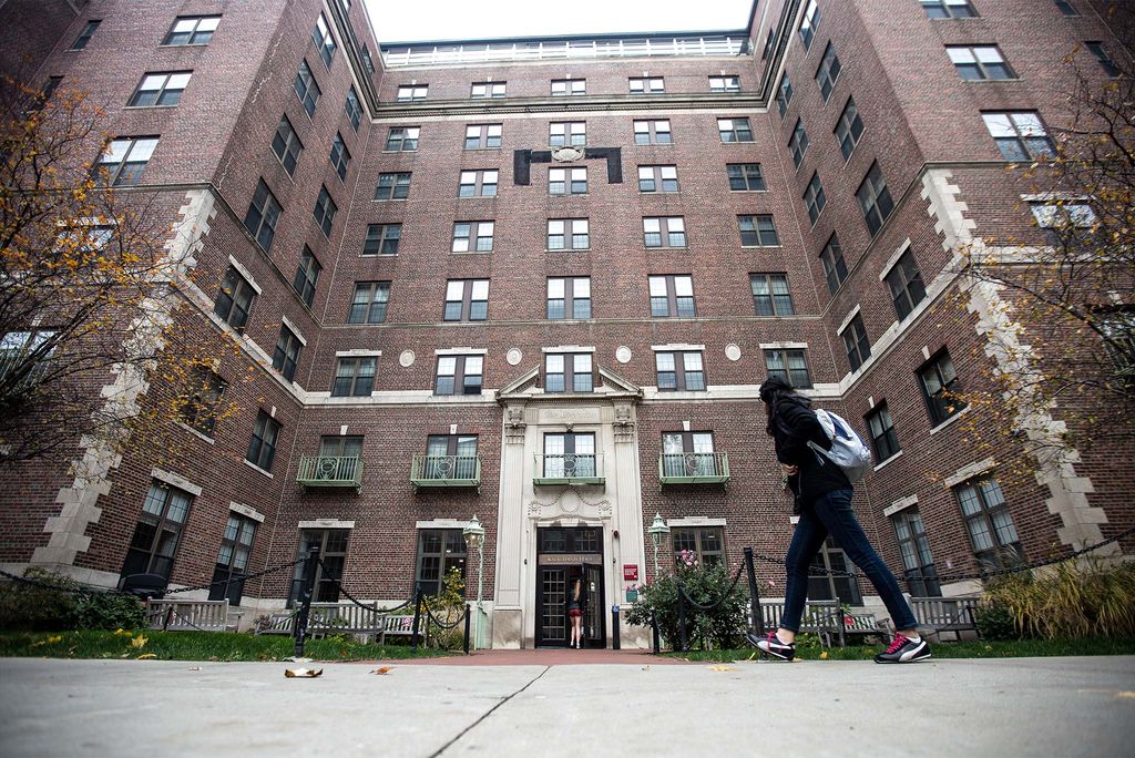 Exterior view of Kilachand Hall at Boston University with student walking in the door.