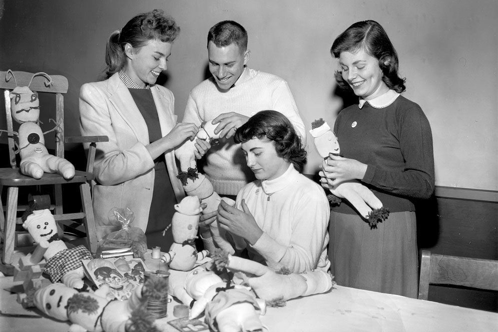 Boston University students are examining a collection of dolls 
