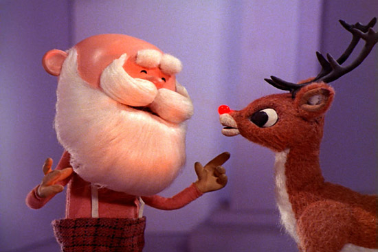 Video still from the 1964 Rudolph the Red-Nosed Reindeer tv special showing Santa Claus talking to Rudolph with his blinking red nose.