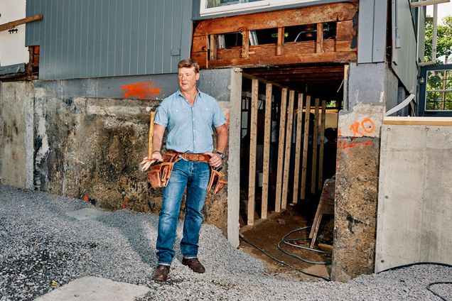 Kevin O’Connor tosses a hammer at a home under construction