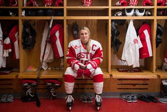 Sammy Davis wears her hockey uniform in the locker room