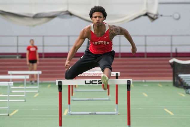Jamie Harris leaps over a hurdle during track and field practice
