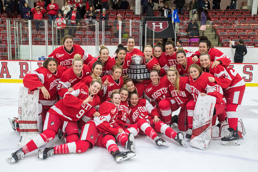 The BU women's ice hockey team poses with the Beanpot Trophy after winning the 41st Annual Beanpot Tournament Championship.