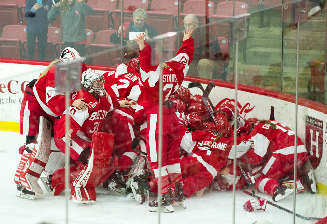 Members of the BU women's hockey team pile onto each other celebration winning the 41st annual Beanpot tournament.