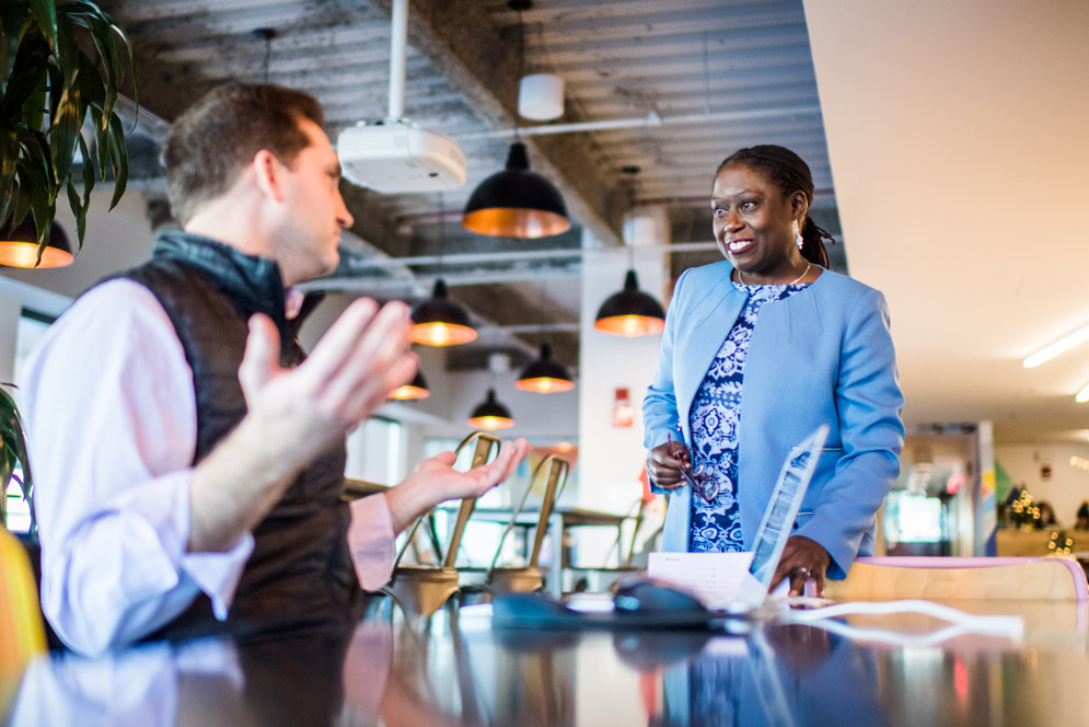 Shakur talks with colleague, Ed Wilson at WeWork