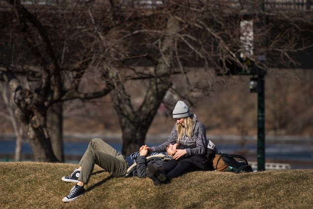 A couple enjoy the unseasonably warm weather on BU beach
