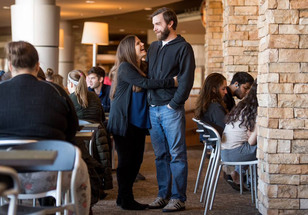 Maddie (Kamin) Murphy (COM’10) and Mike Murphy (COM’09) embrace at the West campus dining hall