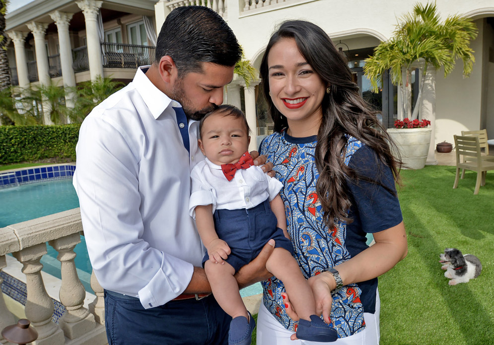 Punit Shah (SHA’02) and Carla Porta Shah (SHA’05), with their infant son, Dev, at their home in Tampa.