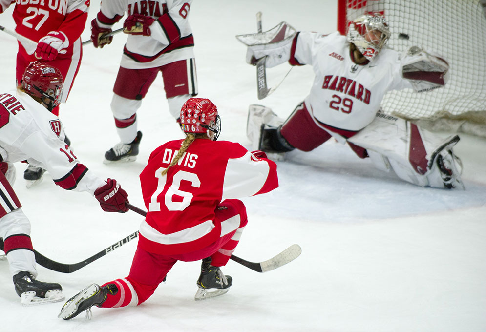 Sammy Davis soots the puck over the Harvard Crimson goaltender's shoulder to win the Beanpot championship in overtime.