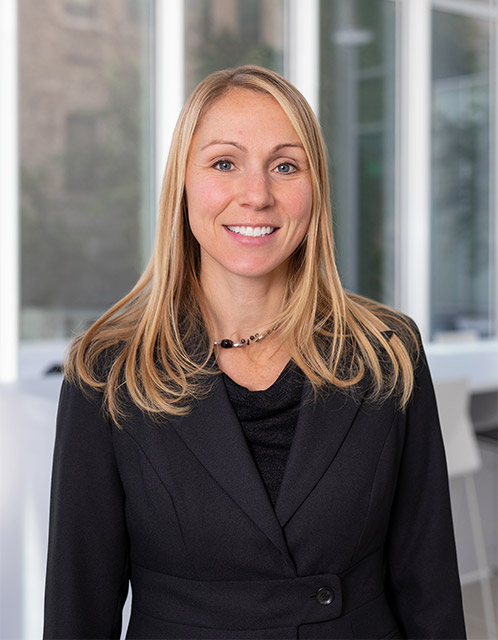 Portrait of Carrie Preston, Director of the Kilachand Honors College at Boston University, standing in front of a building.
