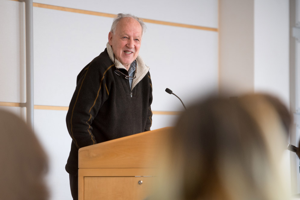 Werner Herzog smiling at a podium