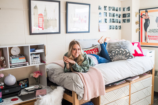 Freshman Kat Ungvary poses on her bed in her dorm room