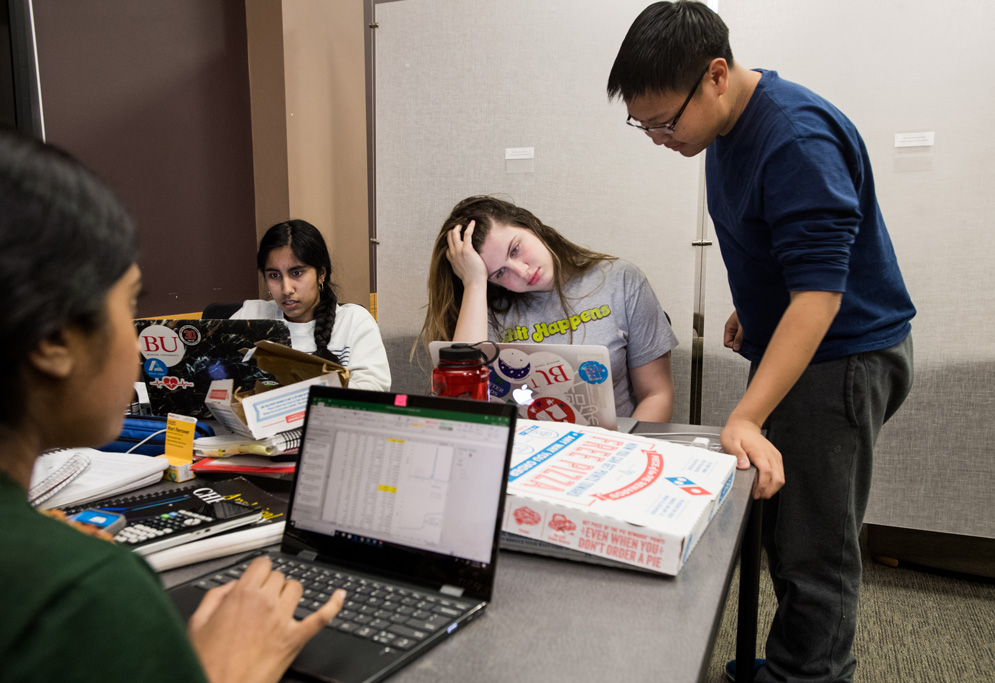 Freshmen Prasida Unni (CAS) (from left), Nishita Sunkara (CAS), Sarah Goldstein (CAS), and David Hou (CAS) study for an upcoming chem lab with a pie from dominos