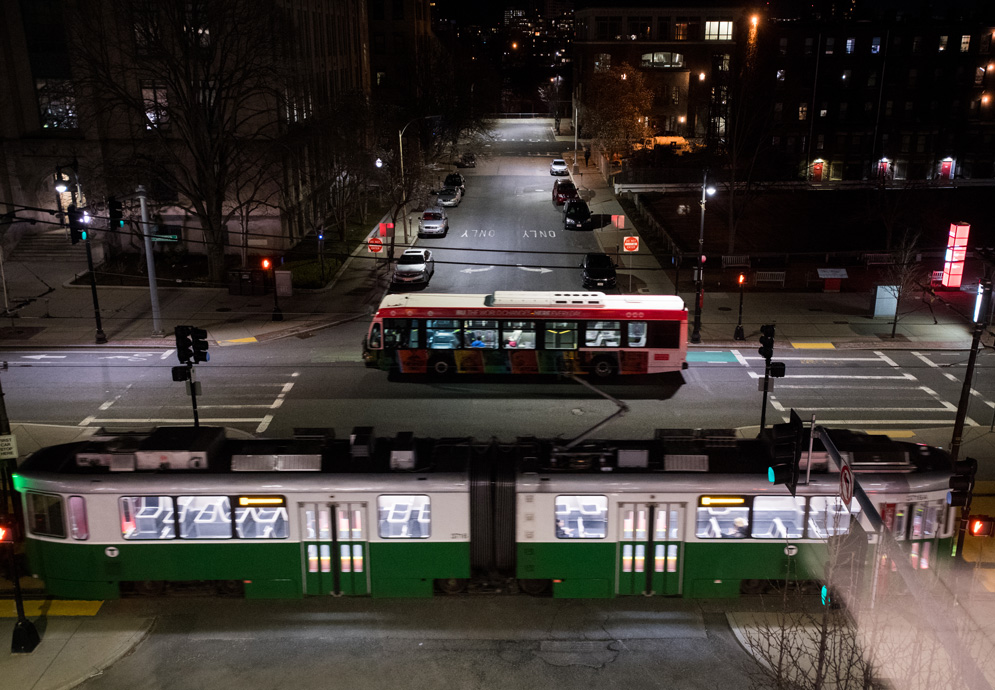 an MBTA Green Line B trolley and the BUS (BU Shuttle) pass on Commonwealth Ave