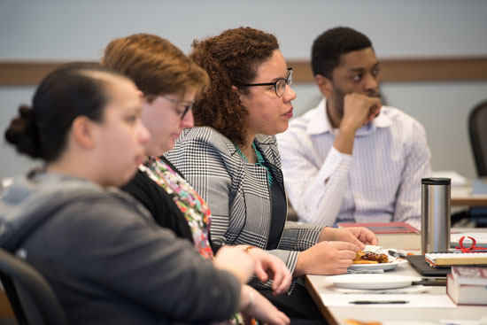 BU law students listening intently around a table