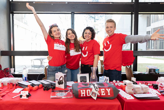Students posing in red giving day shirts