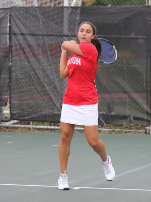 Shelly Yaloz holding a racket, about to swing, while on the tennis court