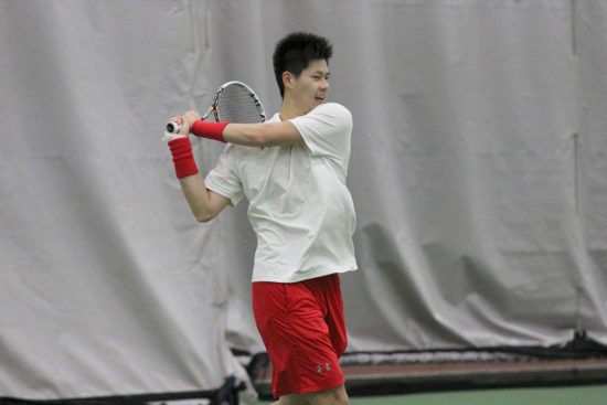 Sophomore Owen Lu swings his racket