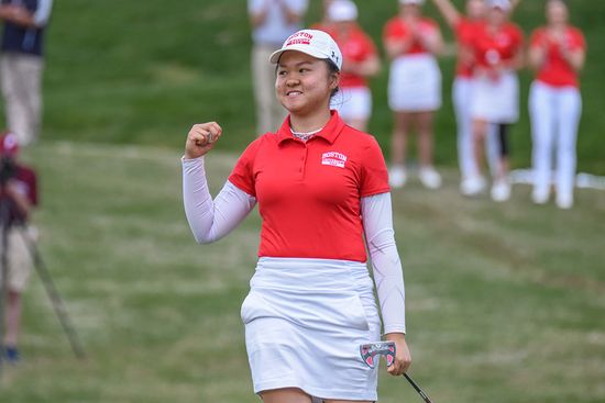 BU women's golf player Hanako Kawasaki smiles after sinking a putt.